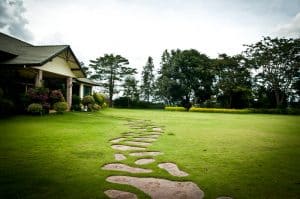 home with asymmetrical stony path