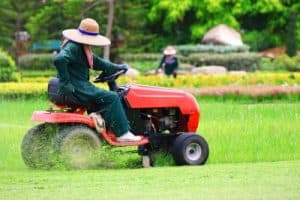 woman on a lawnmower